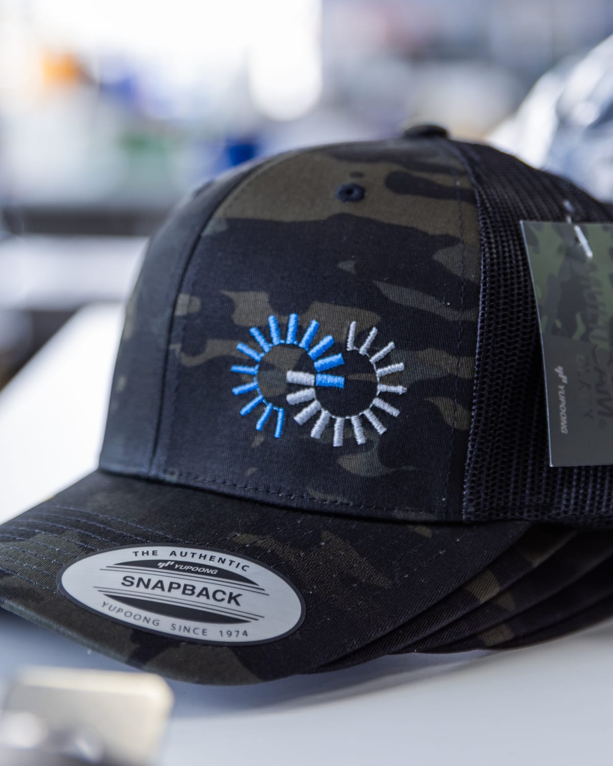 Camo snapback with an embroidered blue logo