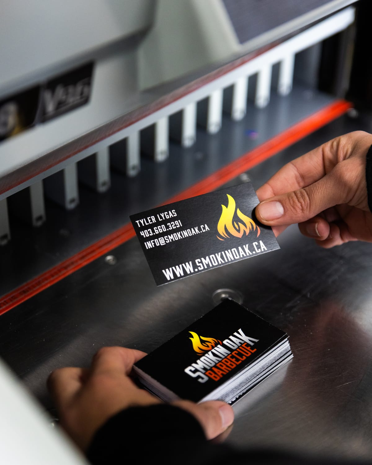 Smokin Oak Barbecue business cards on the paper cutter