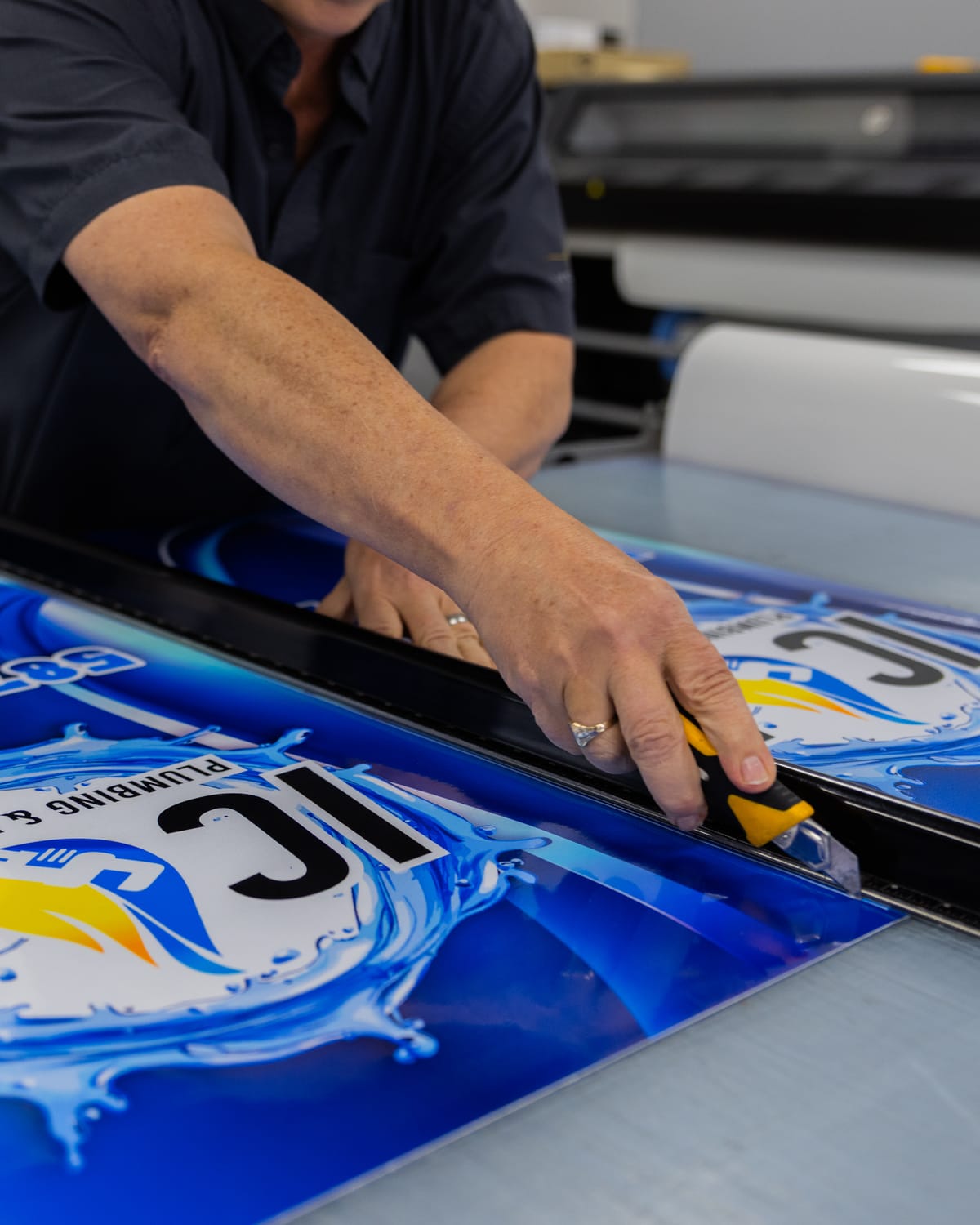 Trimming a printed vinyl panel on the cutting table